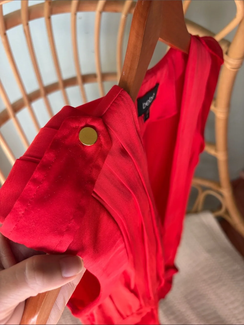 Beautiful Bebe satin vibrant red/orange romper with gold accents.